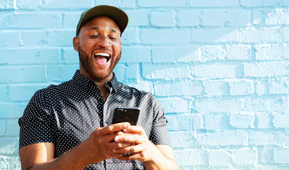 man-laughing-holding-phone