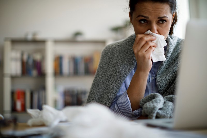 woman-blowing-nose-sick-influenza-virus