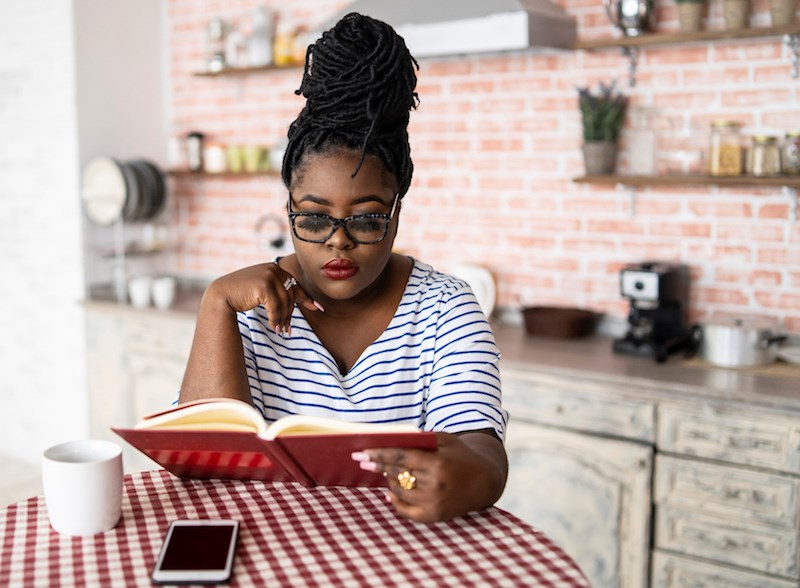 woman-reading-home-kitchen-food