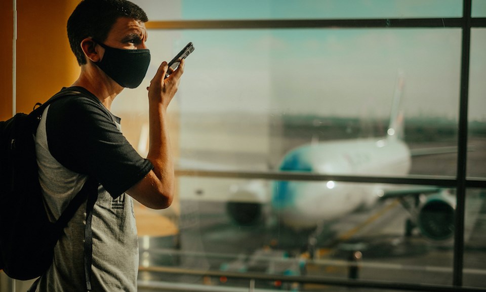 man-mask-airport-on-phone