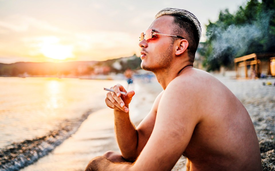 man-smoking-beach-sunset-mexico