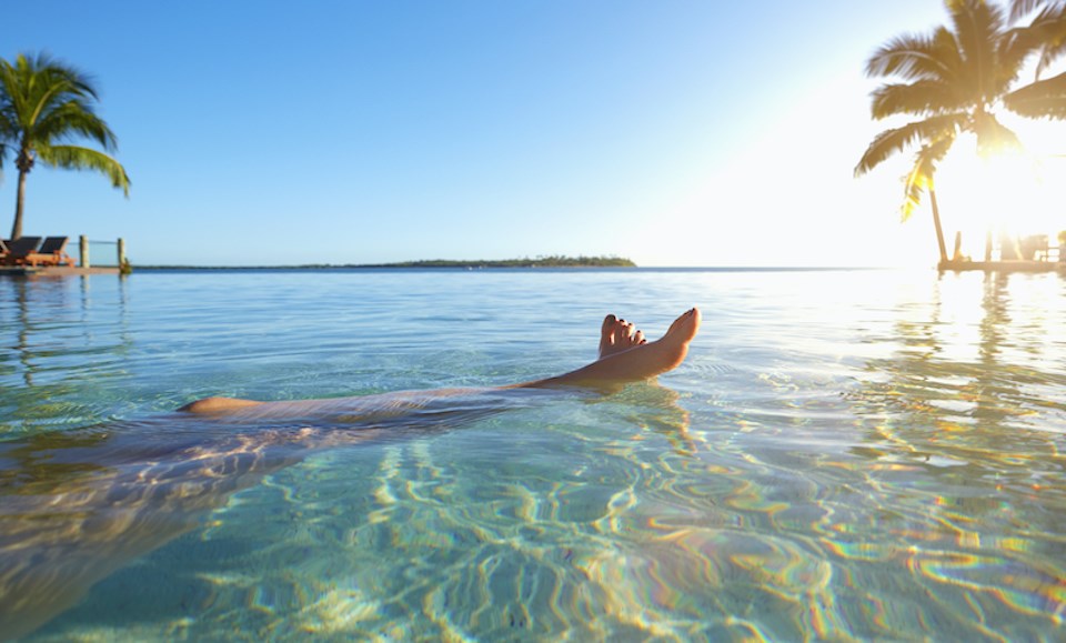 woman-swimming-in-fiji-palm-trees