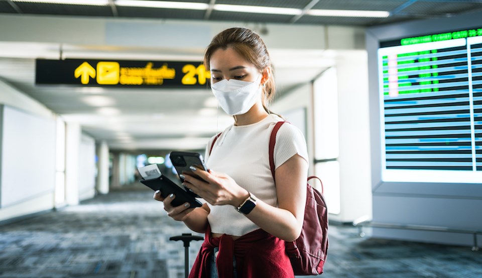 woman-using-smartphone-airport-terminal