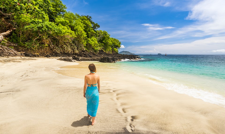 woman-walking-bali-indonesia-beach