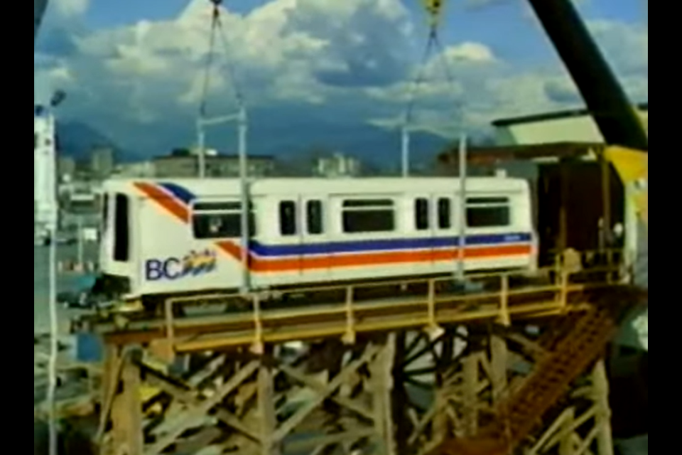 The first SkyTrain car is lowered onto the track, as seen in this 1983 video about the new transit option in Vancouver.