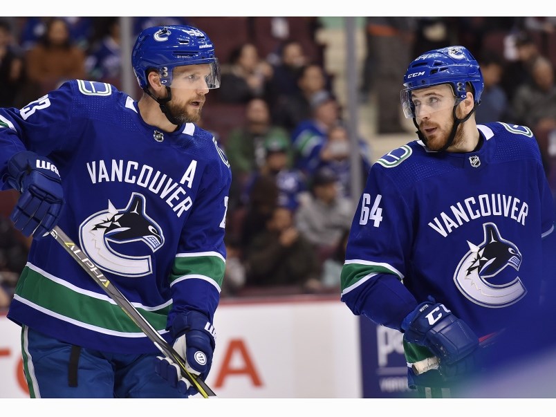 tyler-motte-talks-to-alex-edler-before-a-faceoff