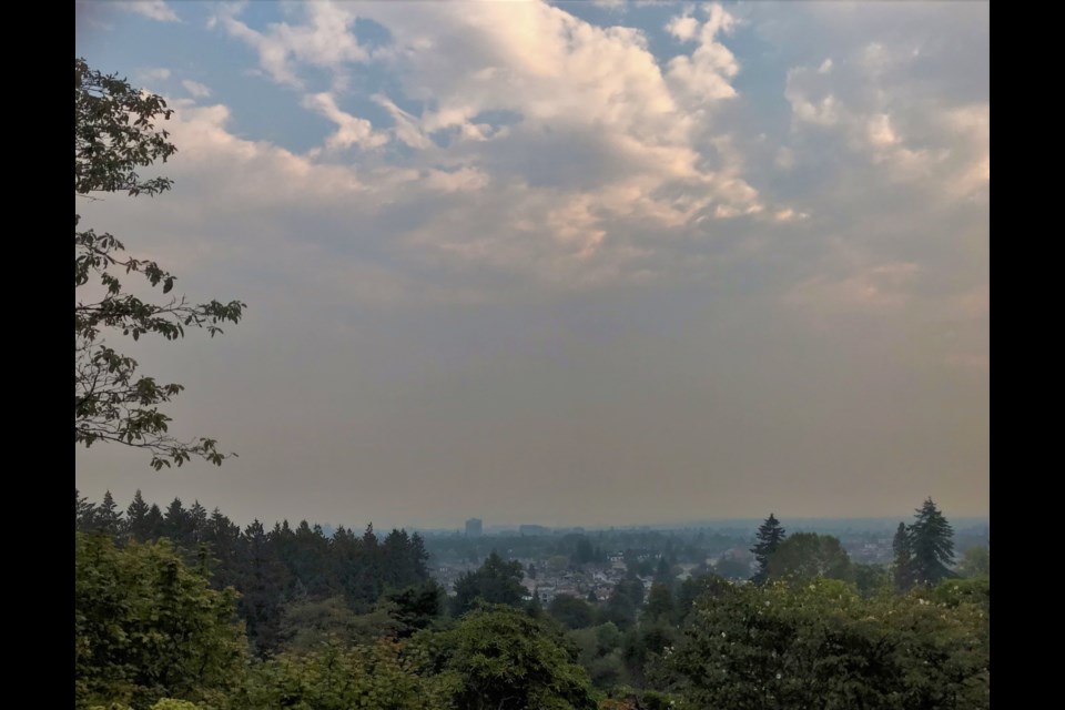 A layer of smoke over the City of Vancouver looking north from Queen Elizabeth Park at the Port of Vancouver and North Shore Mountains.