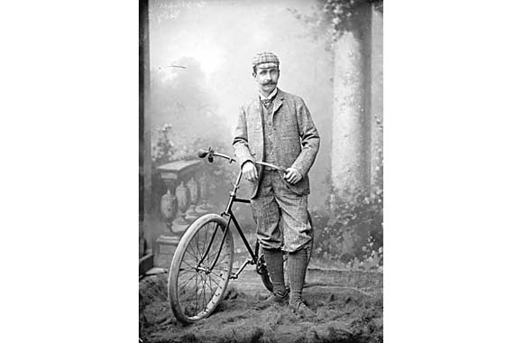 1892 - One of the first cyclists in Vancouver, Charles James Piper, poses with a safety bicycle in a studio.