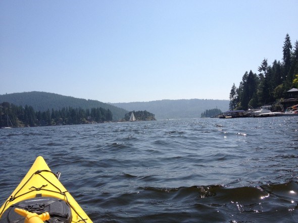 Kayaking along the shoreline of Deep Cove in Vancouver, BC