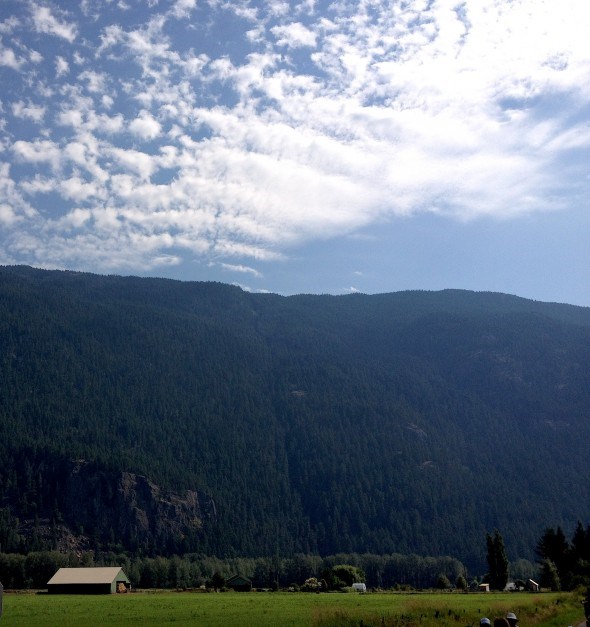 a farmhouse against a dramatic summer sky in Pemberton, BC