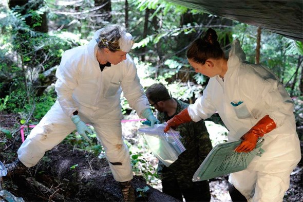  On the right, Ms. Courtney Brown, Coroner, British Columbia Coroners Service; on the left, Ms. Laurel Clegg, Casualty Identification, Department of National Defence. Conducting an initial survey and recovery of remains near the cockpit. May 5, 2014.