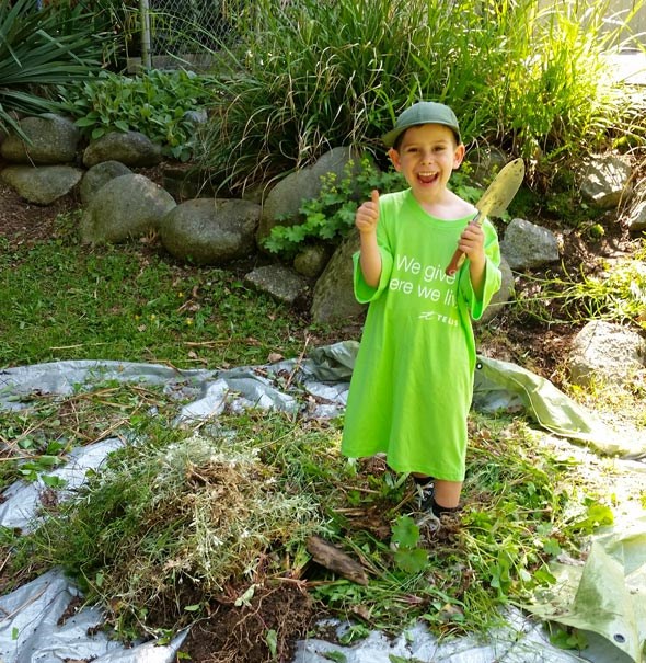  My son Arlo shows off some of the weeds we helped pull at PADS