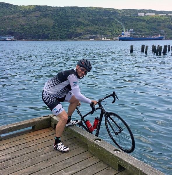  Ned dips a tire into St John's harbour at the beginning of his ride today, with ultimate respect to Terry Fox