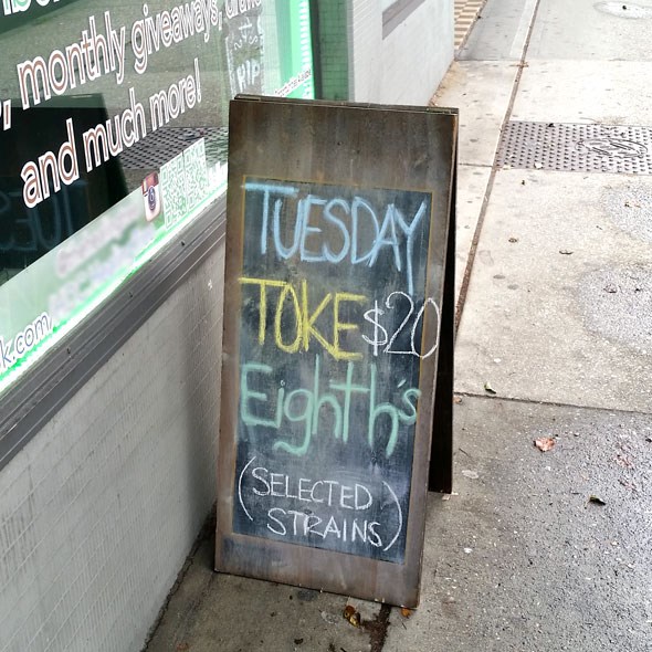  This sandwich board for a dispensary on Broadway shows a smokin' deal every day of the week. Across the street is a bar that's not allowed to sell beer for less than 20 cents/ounce