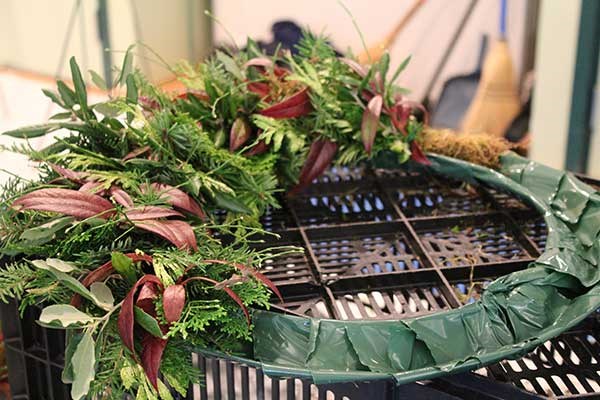  Halfway Point: Bundles of evergreens and other materials are concentrically added to the metal frame