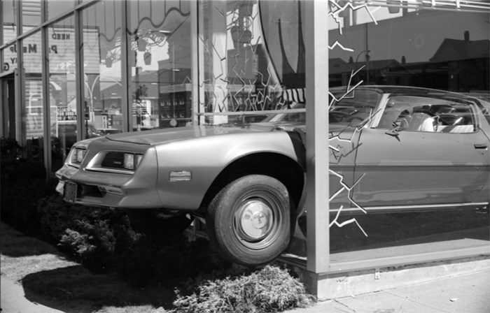  A Pontiac Firebird crashes through the window as part of a car dealership’s window display. Location unknown. Photo City of Vancouver Archives CVA 786-62.19