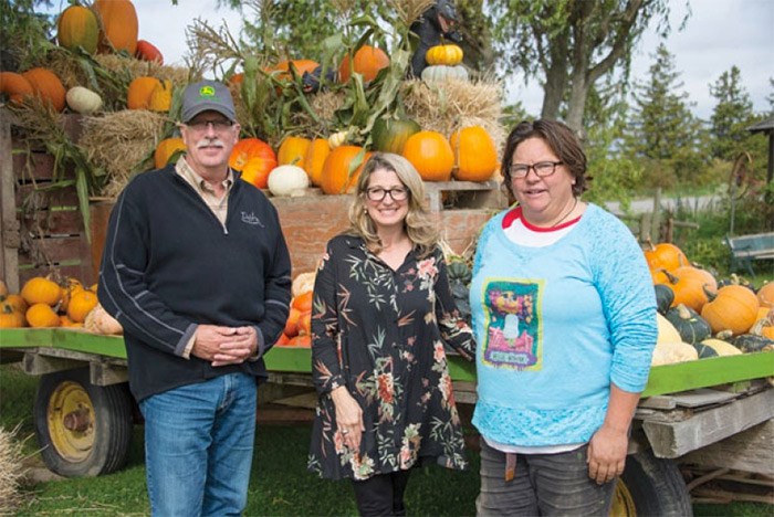  Agriculture Minister Lana Popham (middle) is shown with Delta South MLA Ian Paton and Sharon Ellis of Westham Island Herb Farm during a tour Monday.   Photograph By Adrian McNair