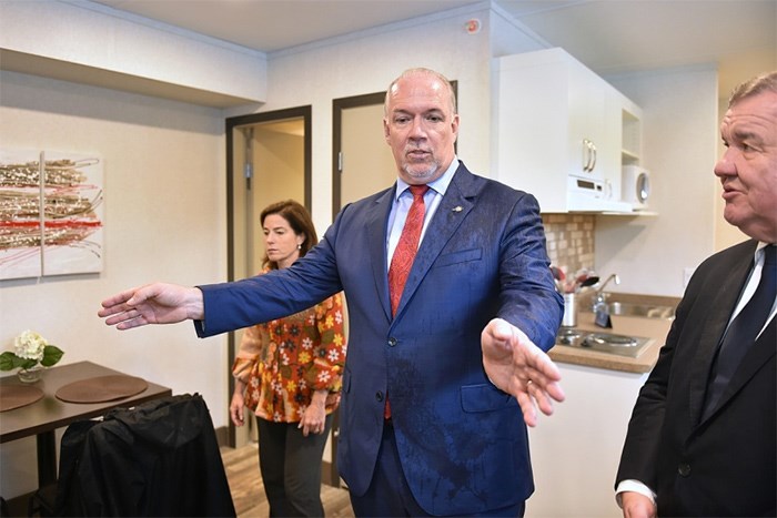 Premier John Horgan, along with cabinet ministers Selina Robinson and Shane Simpson, toured a modular housing display suite Friday at Robson Square. Photo Dan Toulgoet