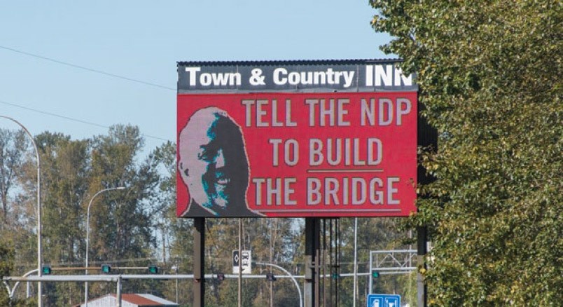  A Liberal campaign supporting a bridge includes this new ad on the Delta Town & Country Inn readerboard.