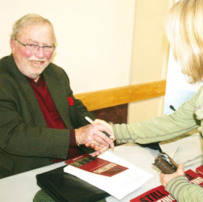  Rafe Mair signs a copy of his book 'Still Ranting.'