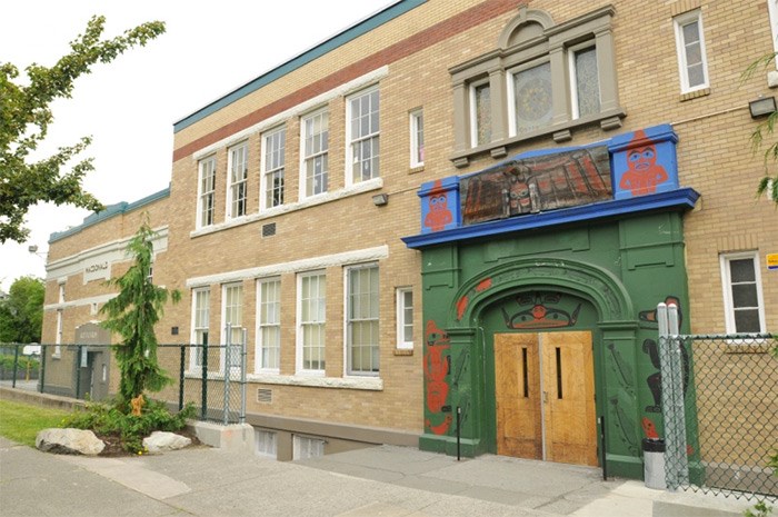  Macdonald elementary, at 1950 East Hastings, features solid oak doors carved by First Nations artist Henry Robertson. Framed by painted figures, and topped by a three-dimensional eagle, the doors’ design depicts salmon swimming as if to spawn, an aboriginal storage box guarded by wolves — protecting education — and a black bear and cubs. Photo Dan Toulgoet