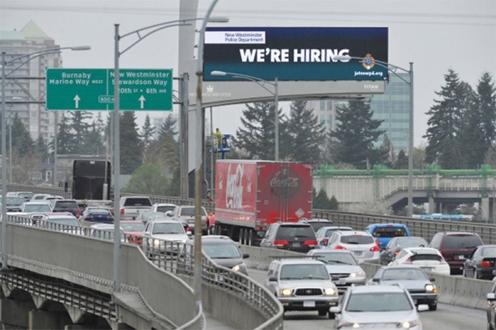  An electronic sign shows off advertising beside the Queensborough Bridge in New Westminstern April 9, 2013.