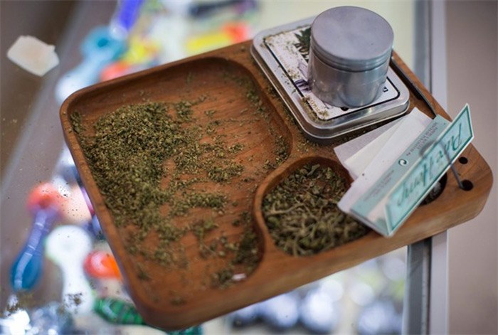  Marijuana and paraphernalia are seen at a Weeds Glass & Gifts medical marijuana dispensary, in Vancouver on Friday, May 1, 2015. Police departments and local governments are asking British Columbia for a cut of marijuana revenues as the province crafts regulations for legalized pot. THE CANADIAN PRESS/Darryl Dyck