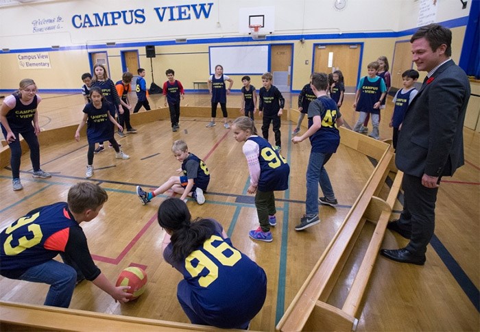  Education Minister Rob Fleming watches Grade 5 students play a game called Gaga ball before announcing a $2.4-million seismic upgrade for Campus View Elementary School in Saanich on Friday, Oct. 27, 2017. Students will not need to be moved: Most of the inside work will be done over two summers.   Photograph By ADRIAN LAM, Times Colonist