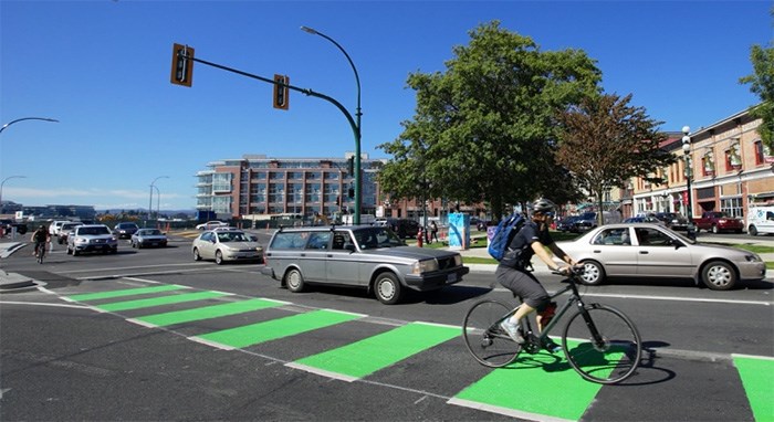  A cyclist rides in a bike lane along Johnson Street in Victoria, well separated from vehicles.