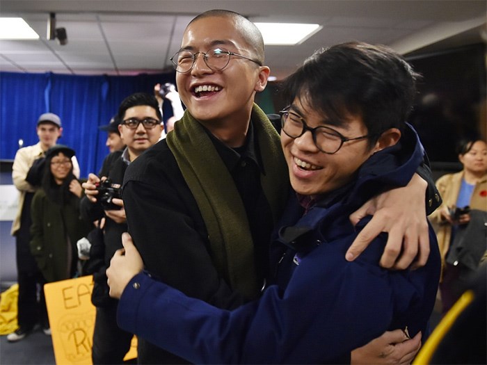  Vincent Tao and Nathanel Lowe celebrate the development permit board's 2-1 decision Monday to reject Beedie's condo proposal for Chinatown. Photo Dan Toulgoet