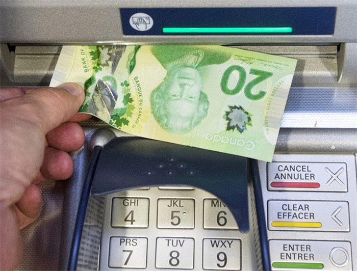  Money is removed from a bank machine in Montreal on May 30, 2016. A new report by Canada's central bank says Canadians favour cash payments over digital ones, especially for smaller sums of money. The Bank of Canada report, based on two surveys conducted by the bank in 2015 and 2013, found 51 per cent of transactions were made in cash in 2015, with debit cards coming next at 31 per cent and credit cards last at 19 per cent. THE CANADIAN PRESS/Ryan Remiorz