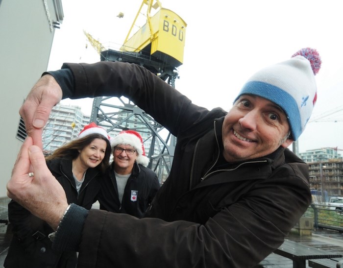  Lower Lonsdale Business Improvement Area executive director Greg Holmes spins a vision of the Sky Wheel for BIA buddies Mitra Sawyer and Andrew Klaver. The BIA is sponsoring a ferris wheel-style ride at the city’s Shipbuilders Christmas Festival Dec. 2-3. photo Mike Wakefield, North Shore News