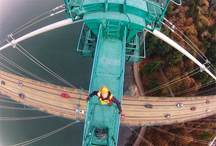  Mainroad Group staffer Paul Welters gets a remote selfie atop the Lions Gate Bridge as traffic rushes by on the deck below. The province has rejected a plan to let tourists climb the bridge’s 110-metre ladders to the top. photo supplied Paul Welters