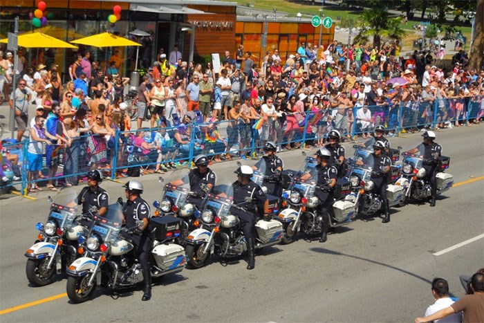  Armed, uniformed police officers ride motorcycles in the 2013 Vancouver Pride Parade.