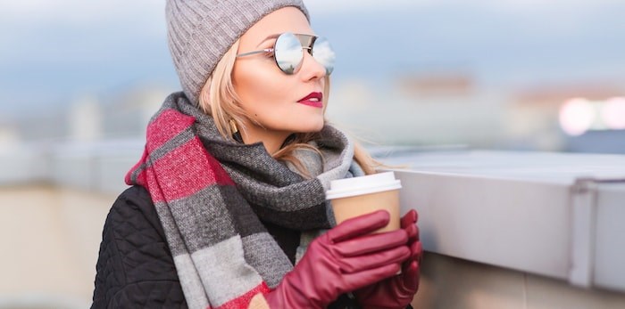  Woman wearing sunglasses in winter/Shutterstock