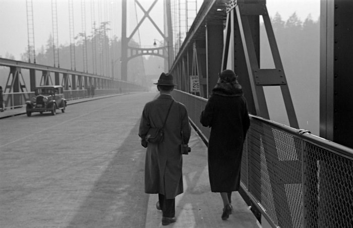  Item: CVA 260-995 - A man and woman walking across the Lions Gate Bridge