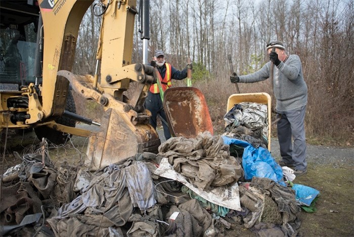  Volunteers from the community spent the weekend pushing wheelbarrows full of heavy debris through the woods.