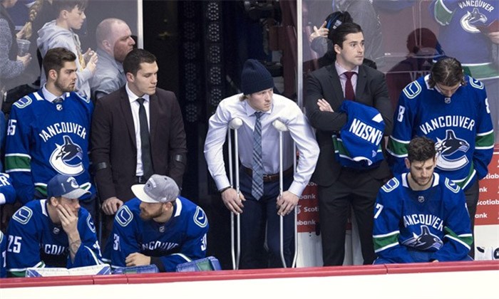  Vancouver Canucks right wing Brock Boeser, centre, is seen with crutches on the bench alongside injured centre Bo Horvat, rear second from left, following a loss to the Calgary Flames in Vancouver, Sunday, Dec. 17, 2017. The struggling and injury-riddled Vancouver Canucks finally got some good news Monday. The club announced on Twitter that star rookie Brock Boeser didn't suffer a fracture after taking a shot off his left foot in Sunday's 6-1 home loss to the Calgary Flames. THE CANADIAN PRESS/Jonathan Hayward