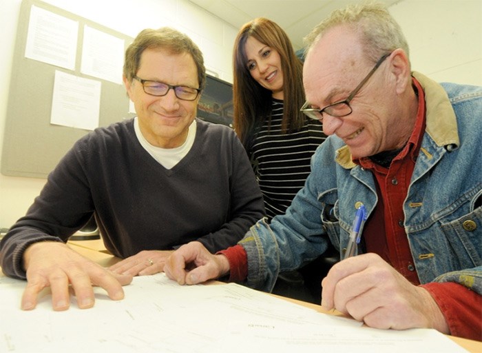  Guy Heywood (left) and Amal Hasan, volunteer co-ordinator with North Shore Neighbourhood House, join Jon Kempf in going over 10 years of back tax returns. The volunteer tax help program helped Kempf get back on his feet. photo Mike Wakefield, North Shore News