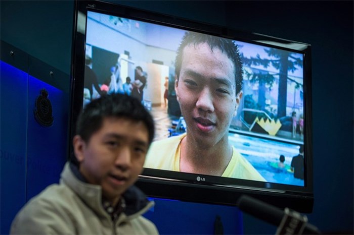  Wilfred Wong speaks about his brother Alfred Wong, 15, seen on a television, who was an innocent victim of an alleged gang shooting, during a Vancouver Police news conference in Vancouver, B.C., on Monday January 22, 2018. Alfred Wong's funeral will be held Saturday. THE CANADIAN PRESS/Darryl Dyck