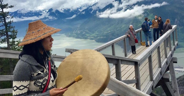  Ecko Aleck of the Nlakapa'mux Nation & Talaysay Tours - Authentic Cultural Experiences performs the Paddle Song — to help loved ones on their journeys to the spirit world — at the Sea To Sky Gondola in Squamish. Talking Trees Tours occur daily at the top of the Summit. (