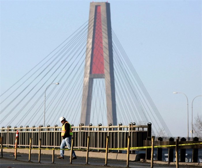  An engineer walks back across the road after assessing the damage to the Pattullo Bridge in Surrey, B.C., on Sunday January 18, 2009. A replacement may be coming for an aging Metro Vancouver bridge with an estimated life span of barely five years. THE CANADIAN PRESS/Darryl Dyck