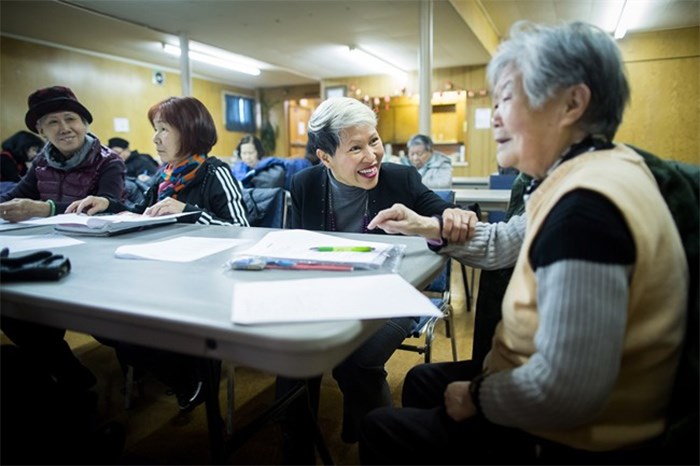  Amie Peacock, centre, founder of the volunteer group Beyond the Conversation, speaks with a senior citizen during a weekly group meeting to help people practice their English skills, combat social isolation and foster relationships, in Vancouver, B.C., on Friday February 23, 2018. The problem of social isolation, which can have serious consequences on a person's mental health and mortality, gained international awareness when the United Kingdom appointed a minister of loneliness in January. Vancouver's Seniors Advisory Committee has developed a report on the issue and delivered its recommendations to city council last month. THE CANADIAN PRESS/Darryl Dyck