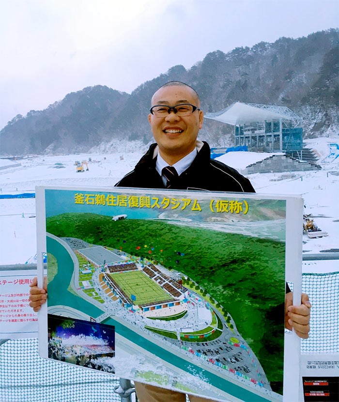  Saski Tomoaki, manager of Recovery Memorial Stadium, holds an artist's rendering of what the completed facility will look like for the 2019 World Cup of rugby. - Cleve Dheensaw