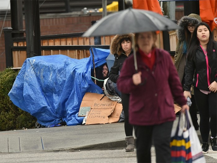  Denis Quesnel, 34, was living under a tarp at Cambie and Broadway Wednesday morning. He was expected to be counted in the city’s annual homeless count, which began Tuesday. Photo Dan Toulgoet