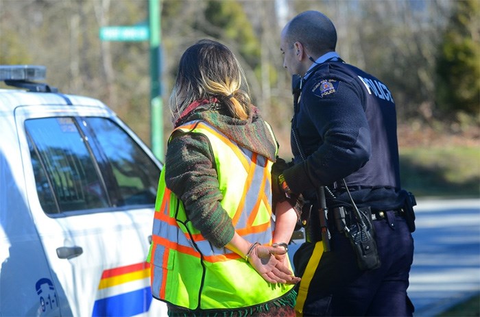  In March, this protester was arrested by police and later charged with mischief for locking herself to a rock truck outside Kinder Morgan's Burnaby Terminal. Photo Cornelia Naylor, Burnaby Now