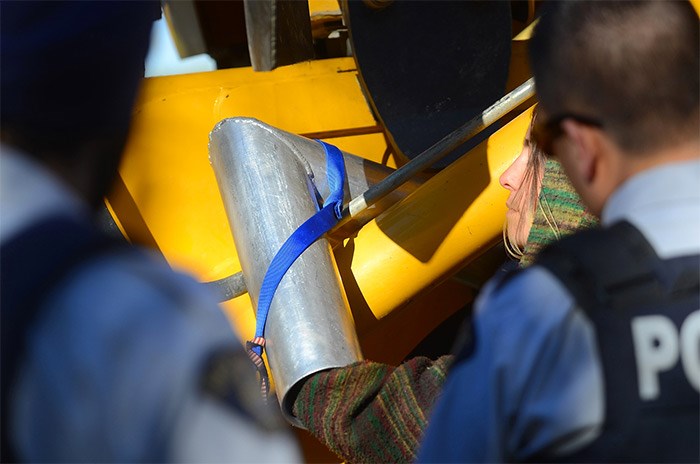  The metal device used to secure the protester's arms around the piece of equipment. - Cornelia Naylor