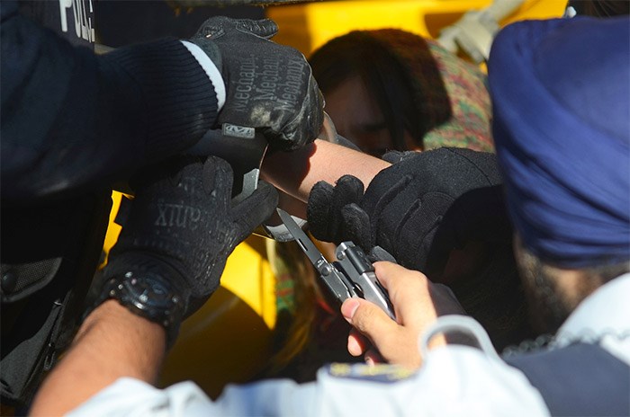  Police used a multi-tool to cut the Velcro straps tied around the protester's hands. - Cornelia Naylor