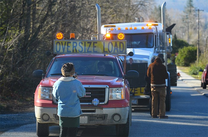  A second truck pulling an excavator is stopped by protesters. - Cornelia Naylor