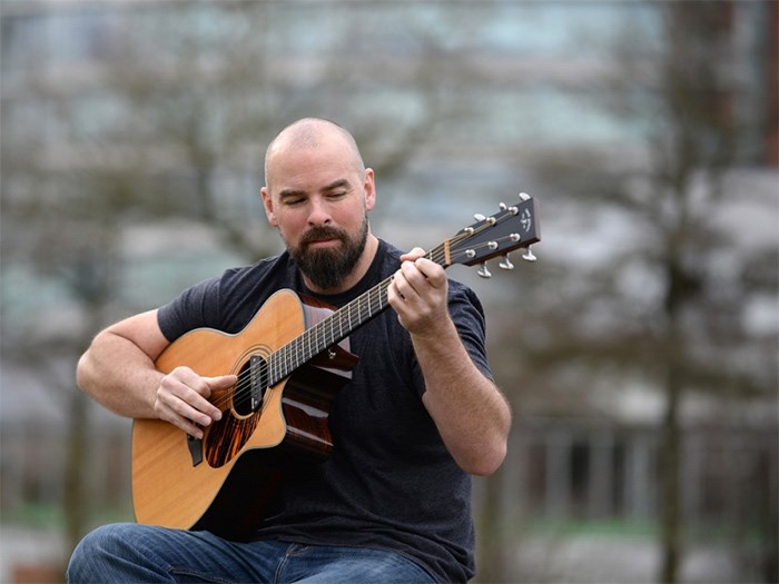  Kris Schulz is getting the band together for an afternoon of free guitar lessons at International Village Mall.